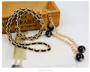 Women fashion gold black chain belt detail, elegant metal waist chain with round beads.