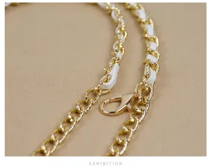 Stylish women's metal chain and white leather strap detail, versatile fashion accessory.