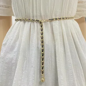 Elegant gold chain belt with black leather weave, perfect for dresses and skirts.