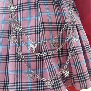 Detailed view of the trendy punk style multi-layer silver chain belt with cute butterfly charms.