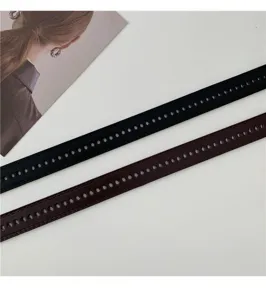 Detail view of multi-hole waist belt in black and brown, perfect for military training.