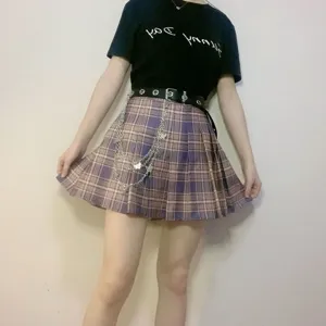 Punk style metal waist chain with butterfly charms paired with jk plaid pleated skirt detail shot.