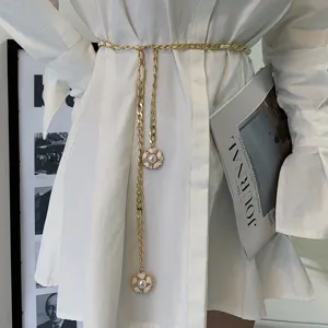 Gold chain belt with white camellia pendant for women, stylish dress accessory for waist.