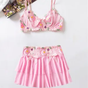 Pink floral mesh embroidery bra and lace mini skirt set detail, showcasing delicate strap design.