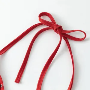 Close-up of red adjustable halter strap detail for sexy lingerie and swimwear set.