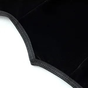 Black velvet corset detail shot showcasing fine stitching texture and gothic design style craftsmanship.