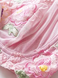 Detailed shot of pink mesh floral embroidered lingerie bralette, sweet and delicate design.