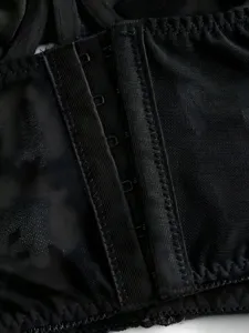 Close-up detail of women's black mesh gothic corset top featuring hook-and-eye closure.