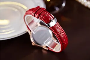 Red leather strap women's watch detail, rose gold case and silver buckle for chic style.