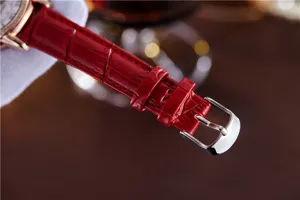 Red leather watch strap with silver buckle, detailed macro view for women's quartz watch accessory.
