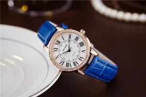 Detailed shot of elegant women watch with blue leather strap, diamond bezel and Roman numerals.