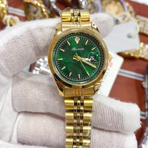 Green dial gold stainless steel strap women quartz watch with calendar display detail view.