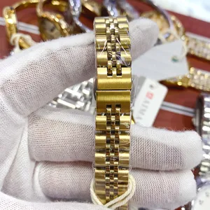 Gold metal watch strap for women, stylish stainless steel replacement bracelet, durable.