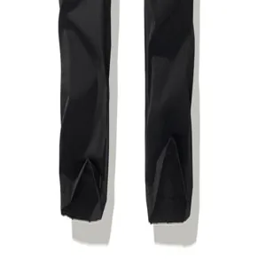 Detailed view of men's black slim casual pants with stylish hem design for daily wear.