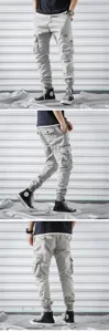Men's casual light grey cargo pants with multiple pockets and elastic cuffs for sports.