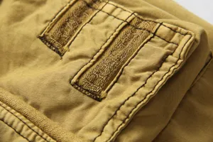 Detailed view of mens casual cargo pants featuring durable khaki fabric and sturdy stitching.