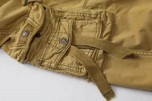 Close-up detail of mens casual cargo shorts pockets, khaki cotton fabric, stylish metal buttons.