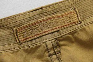 Men's casual cargo shorts detail view, khaki cotton fabric, durable belt loop with woven label.