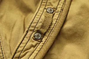 Detailed close-up of mens casual cargo shorts featuring durable fabric and metallic button accents.