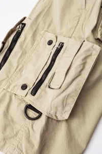Detail view of men casual khaki cargo pants with multiple utility pockets and hardware.