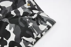 Close-up detail shot of mens black and white camo cargo shorts featuring sturdy belt loops.