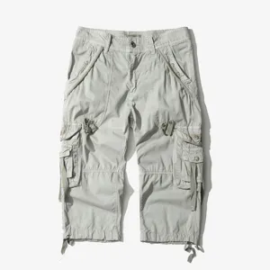 Light gray multi-pocket cargo capri pants detail, showing tactical pockets and fabric.