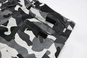Detailed view of mens black white camouflage cargo shorts showcasing durable ripstop fabric.