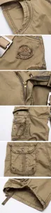 Men's casual cargo shorts detail view, khaki cotton fabric with multi pockets and zip fly.