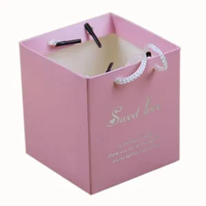 Pink square paper gift bag candy box with elegant handle for wedding party favors and events.