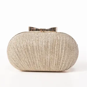 Elegant gold glitter evening clutch bag with chic metal bow lock for women parties.