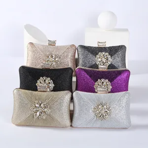 Glitter evening clutch bag featuring sparkling crystal floral clasp and elegant pleated design.