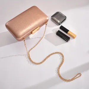 Exquisite rose gold evening clutch bag with chain strap, smooth texture, elegant party purse.