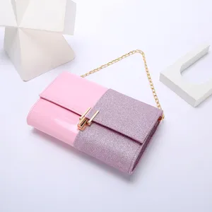 Detailed view of women's pink glitter evening clutch bag with gold chain strap for party.