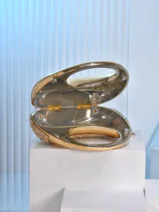 Gold crescent acrylic evening clutch bag, elegant metallic ring handle mini purse for party.