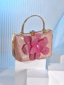 Elegant pink glitter evening clutch bag with stunning rhinestone flower and gold handle.
