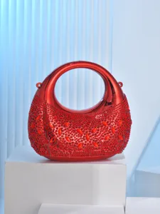 Red metallic moon evening bag featuring sparkling rhinestones for chic party styling.