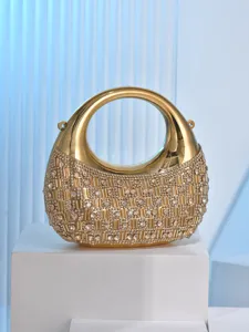 Stunning gold rhinestone evening bag featuring a unique crescent shape and sparkling crystals.