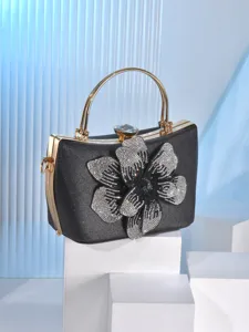 Elegant black rhinestone flower evening bag with gold handle and clutch design for women party.