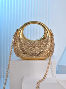 Close-up detail of the gold rhinestone evening bag featuring sparkling crystals and chain.
