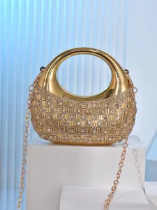 Elegant gold evening bag with rhinestone crystals, round metal handle, and chain strap.