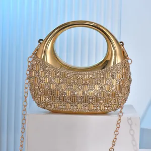 Gold crescent evening bag with rhinestone crystals, round metal handle and chain strap for women.