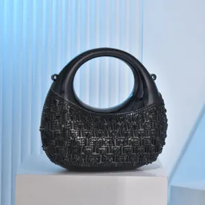 Black crescent acrylic evening bag with sparkling rhinestones, elegant crossbody mini handbag.