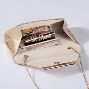 Interior detail of the sparkling gold evening clutch bag with practical storage and chain strap.