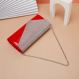 Red rhinestone evening clutch bag detail, sparkling crystal party purse with chain strap.