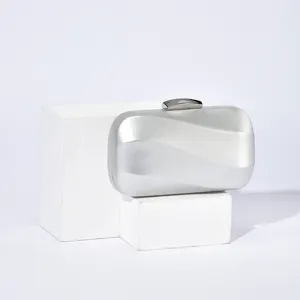 Silver metallic evening clutch bag with metal lock detail, elegant fashion accessory for party.
