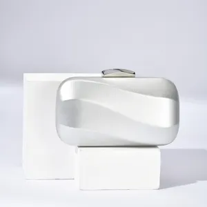 Silver evening clutch bag for women, elegant metallic lock design, perfect for party and wedding.