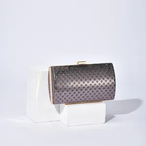 Elegant metallic evening clutch bag with lock closure and stylish dotted texture for women