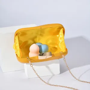 Yellow evening clutch bag featuring a gold-tone metal lock and chain strap detail.