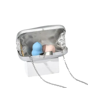 Silver evening clutch bag for women with metallic lock and chain strap, elegant party purse.