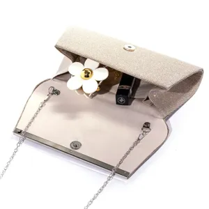 Glitter evening clutch bag detail showing interior compartment, magnetic closure and metallic chain.